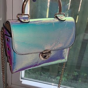 A cute chrome cross body purse for Adults or kids